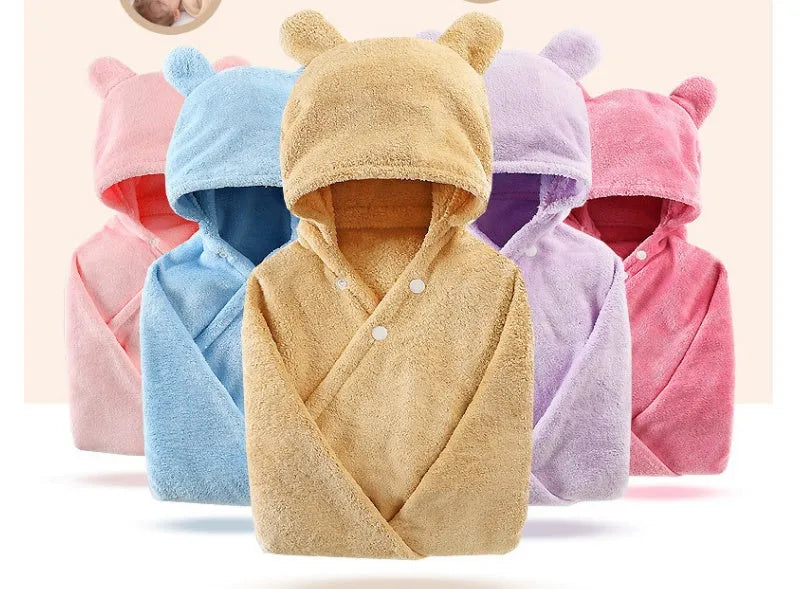 Blue hooded baby bath towel with dimensions 65cm by 110cm laid flat.