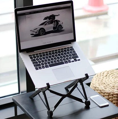 Black folding laptop stand made of reinforced nylon, shown supporting a silver laptop at an angle.