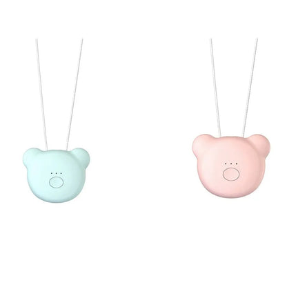 Small pink wearable air purifier pendant on a necklace, showing USB charging port and single button.