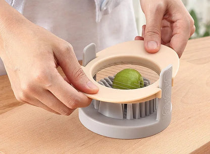 Three-function manual egg cutter in blue with stackable design for kitchen use