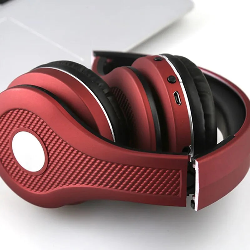 Metallic finish Bluetooth over-ear headset shown in black, red, blue, and gold colour options.