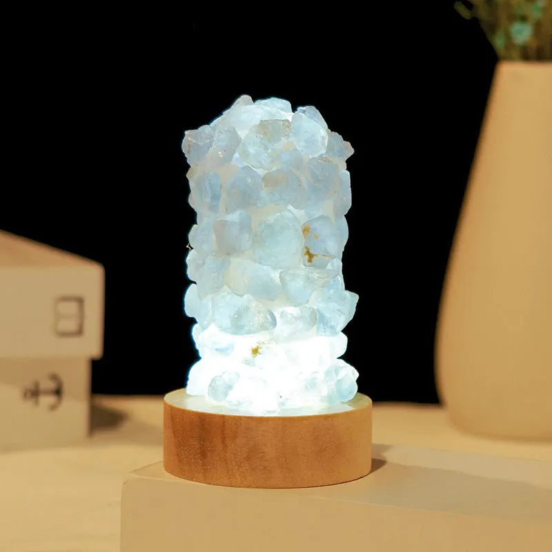 Mini USB night light glowing inside a natural amethyst crystal vug geode on a dark surface.