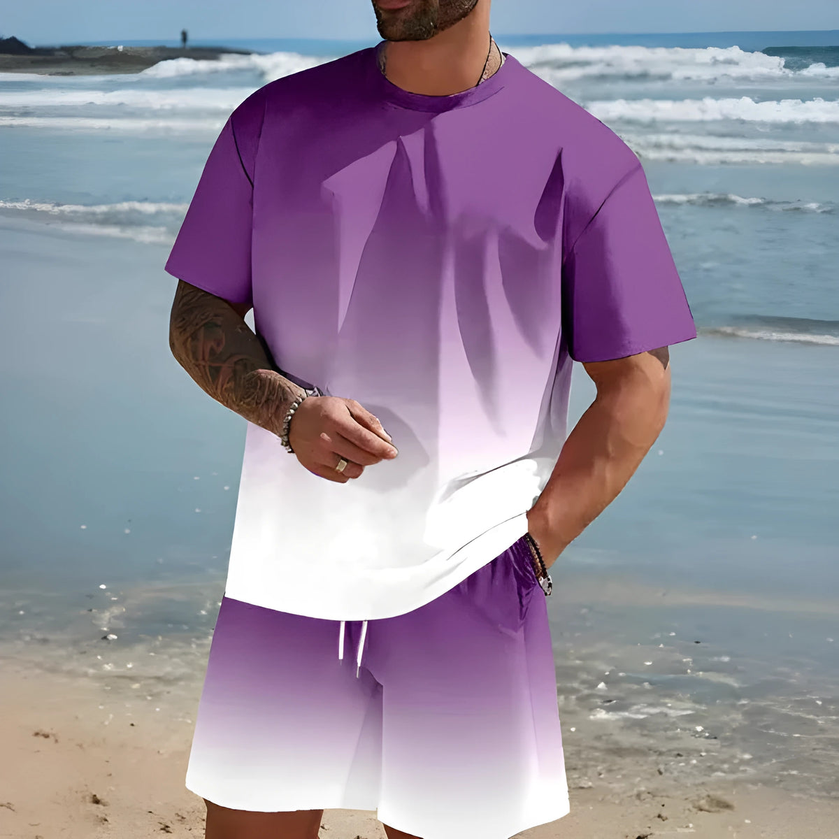Man wearing a loose fit grey short-sleeved t-shirt and matching shorts from a summer leisure suit.