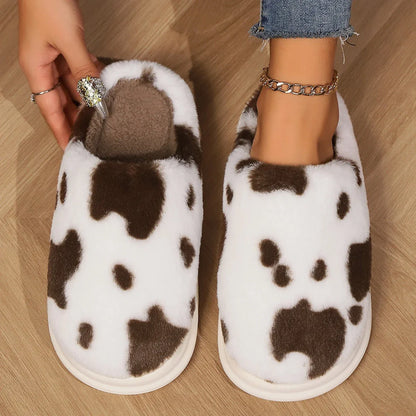 Cozy cow print plush slippers with soft, cushioned soles and non-slip outsoles for indoor comfort and warmth