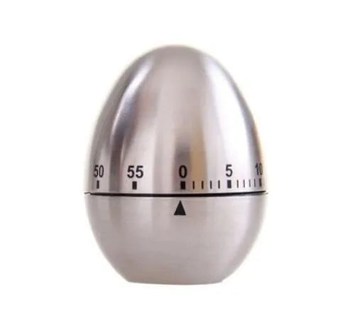 Stainless steel egg-shaped mechanical kitchen timer on a countertop.