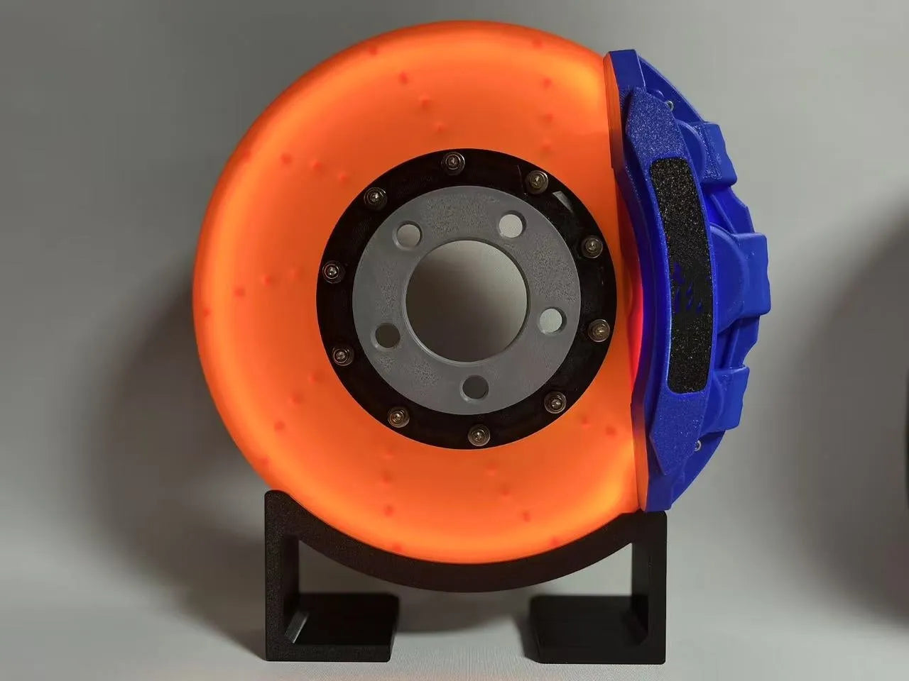 Brake disc design LED night light with caliper details in blue, red, or yellow colour options on desktop