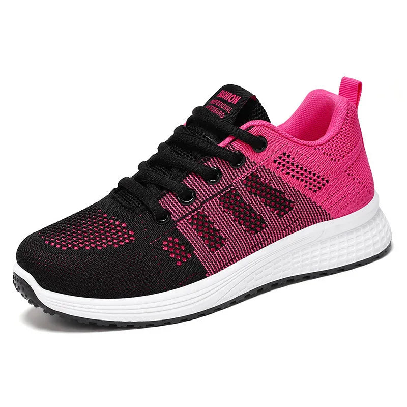 Women's flyknit running shoes in grey pink with soft sole and lace-up front.