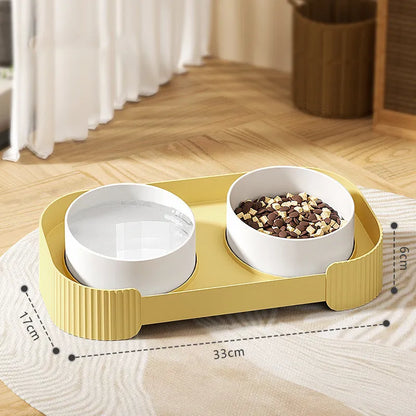 Green ceramic elevated cat bowl set with two tilted dishes on a stand with a spill-proof rim