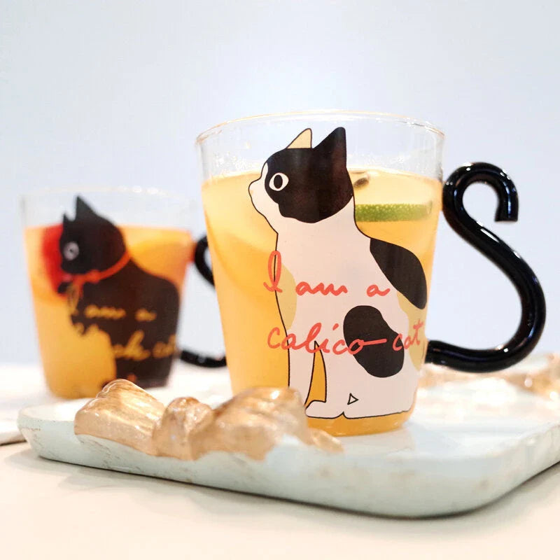 Adorable cat-themed glass mug with a whimsical cat-shaped handle, perfect for coffee, tea, and juice lovers