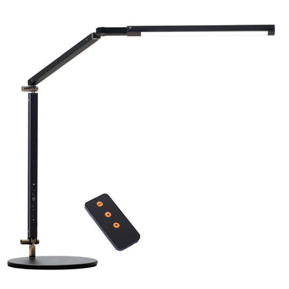Adjustable aluminium desk lamp with remote control, shown in black with a clip attached to a desk edge.