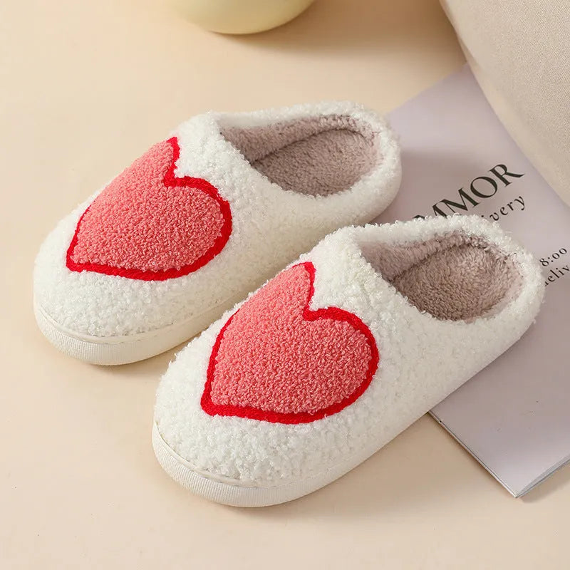 Adult women's plush home slipper in a cartoon love design with a round toe and non-slip PVC sole.