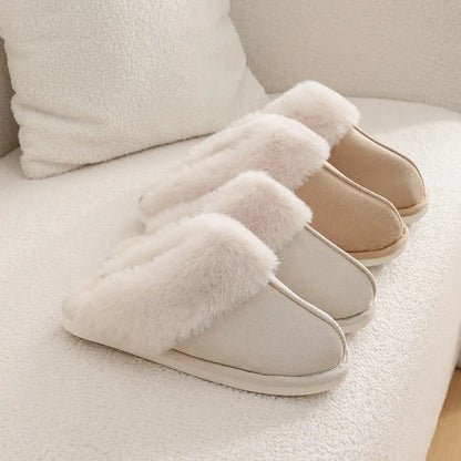 Women's plush winter slippers with round toe, flat heel, and stitching detail on a non-slip PVC sole.
