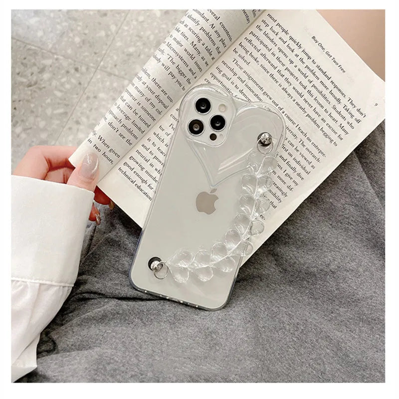 Transparent TPU iPhone case with love bracelet heart chain design on a mobile phone.