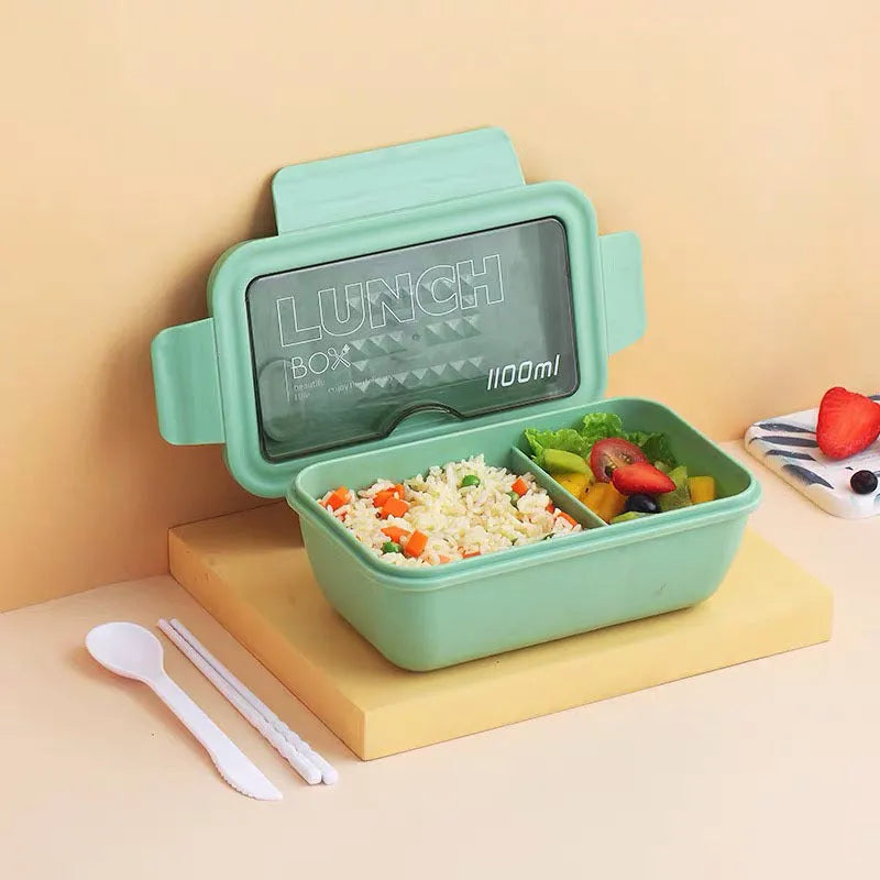 Green four-layer stacked plastic bento box with separate compartments for food, shown next to red and yellow options.