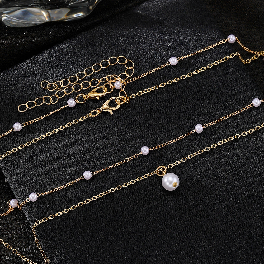 Elegant gold pearl tassel necklace with double-layered design and adjustable chain