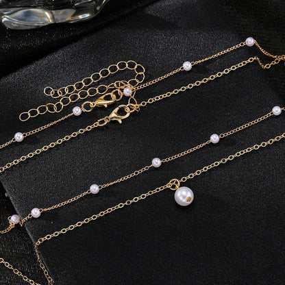 Elegant gold pearl tassel necklace with double-layered design and adjustable chain