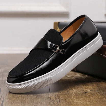 Men's black slip-on shoes with a gold horsebit buckle detail and round toe.