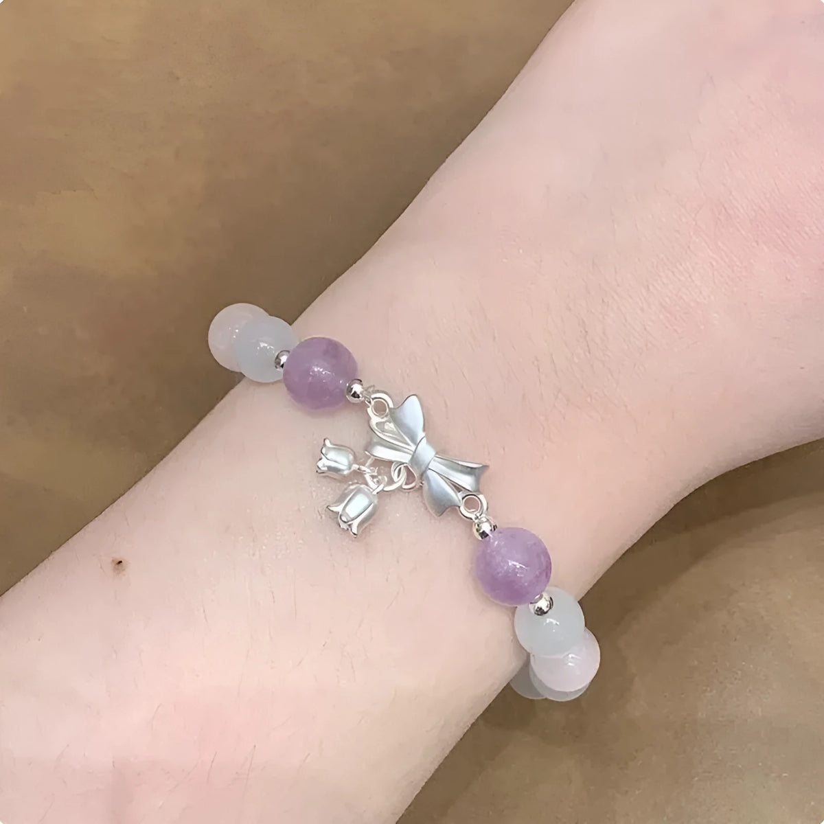 Lavender amethyst opal bracelet with crystal bowknot charm measuring 10mm