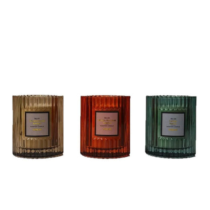 Soy wax aromatherapy candle in cylindrical shape showing red, green and amber colour options