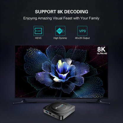 Compact black Android TV set-top box with HDMI port, remote control, and power cable.