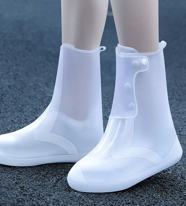 White high-top PVC waterproof shoe cover for women, shown on a foot.