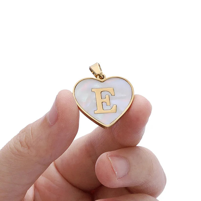 Gold-plated heart necklace with white shell pendant showing letter personalisation option