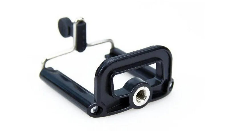 Black mini camera tripod with extended legs and a separate U-shaped universal phone clip on a table.