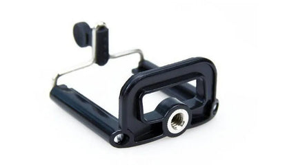 Black mini camera tripod with extended legs and a separate U-shaped universal phone clip on a table.