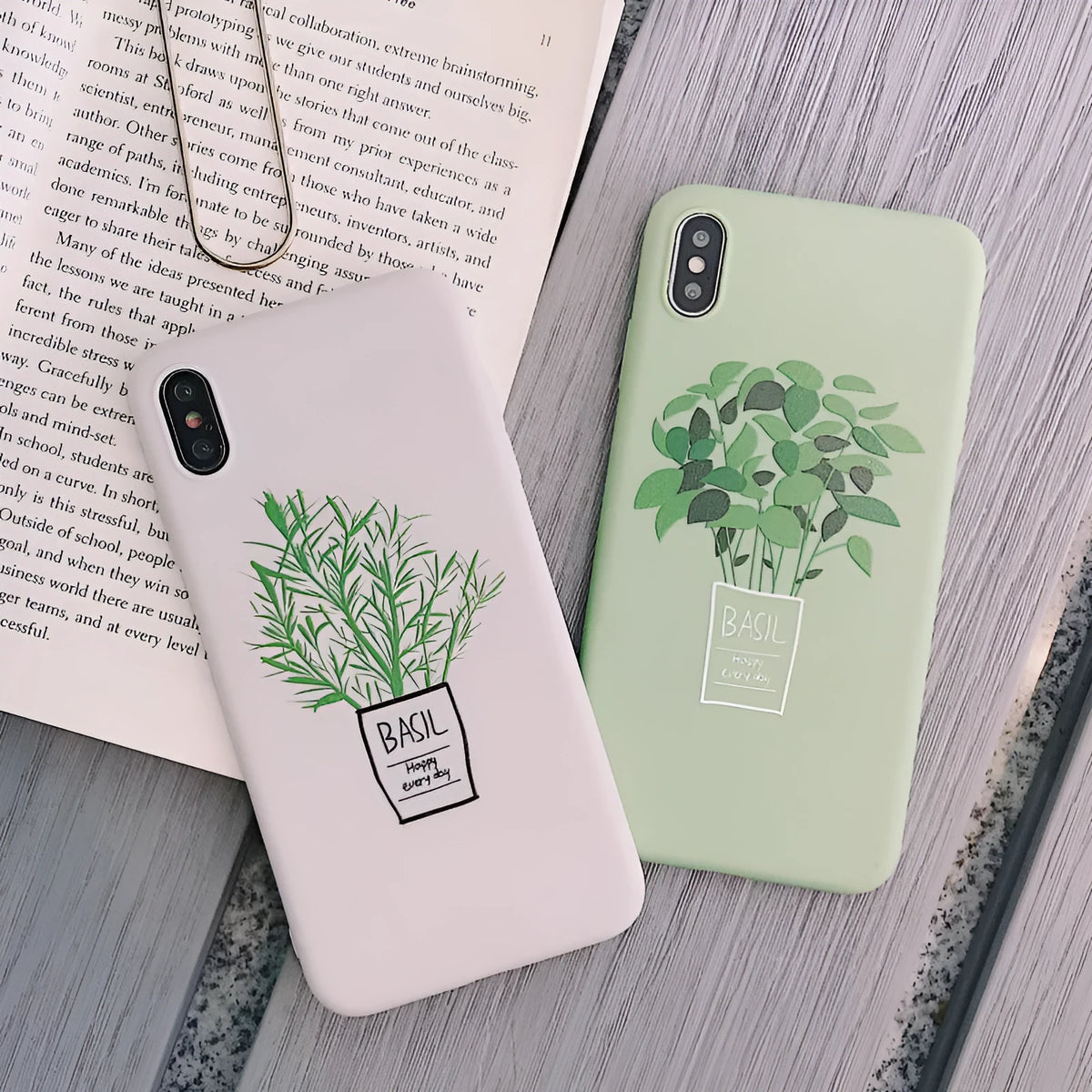 White silicone iPhone case with a painted green leaf plant design on the back.