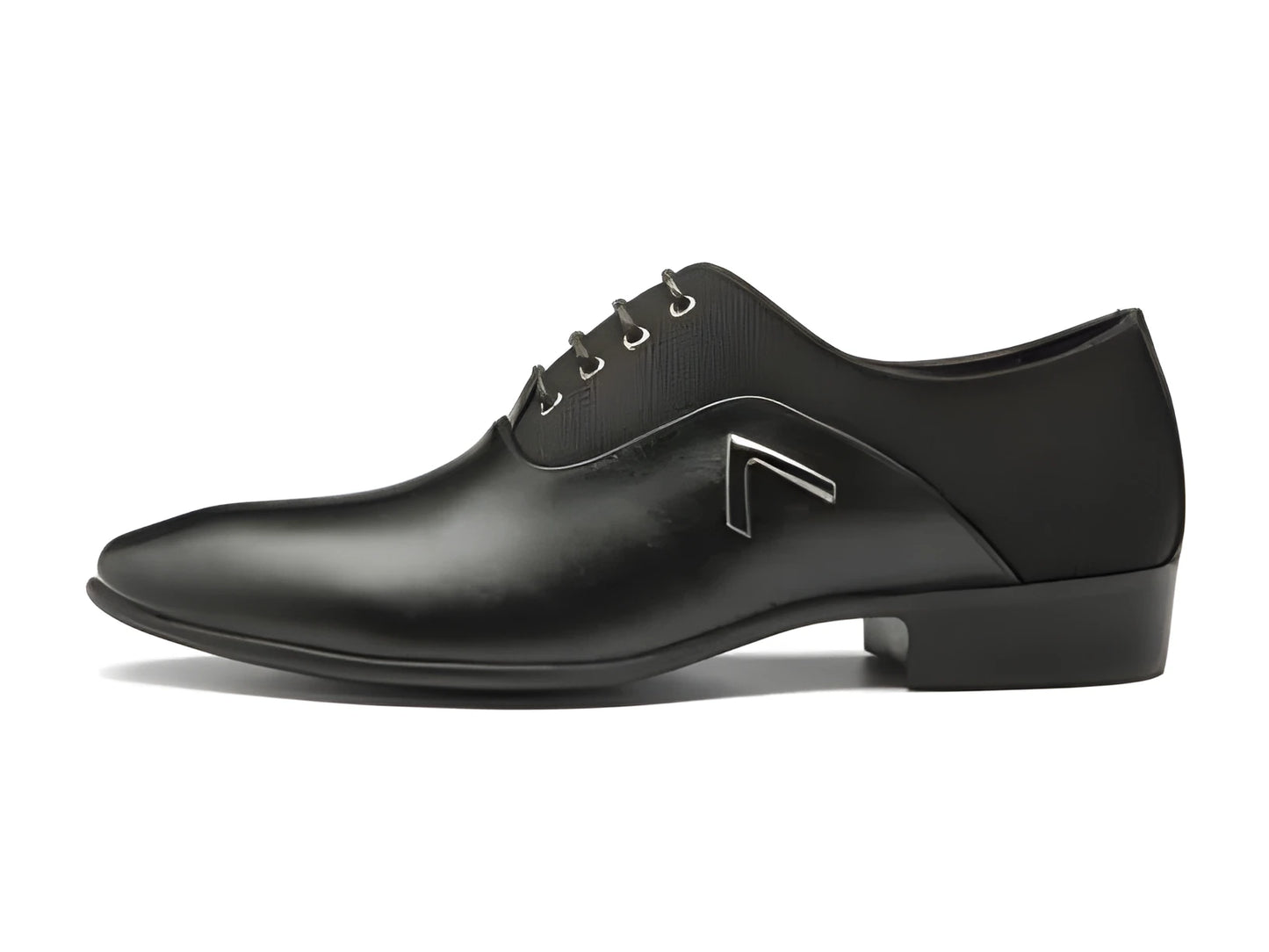 Men's black Oxford dress shoes with a rubber sole on a wooden floor.