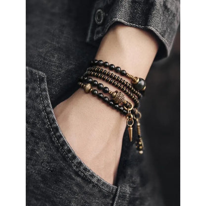 Black geometric beaded bracelet with multi-layered colourful design on wrist