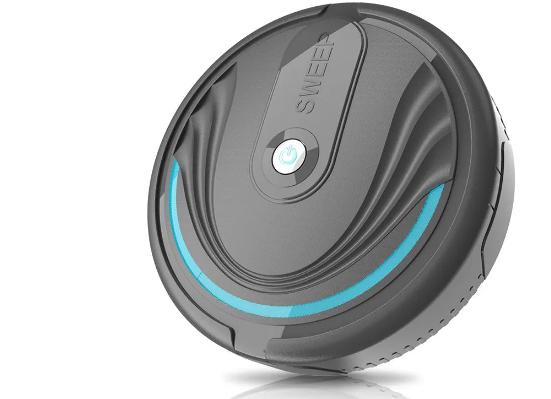 Black automatic sweeping robot vacuum cleaner with remote control on a wooden floor.