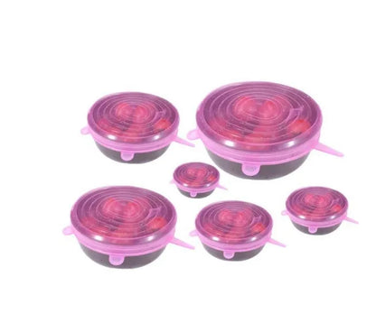 Set of six flexible silicone pot lids in assorted sizes on a kitchen counter.
