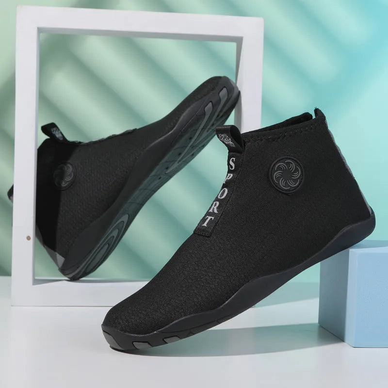 Mid-top outdoor beach shoes in black and fluorescent green with mesh upper and rubber sole.
