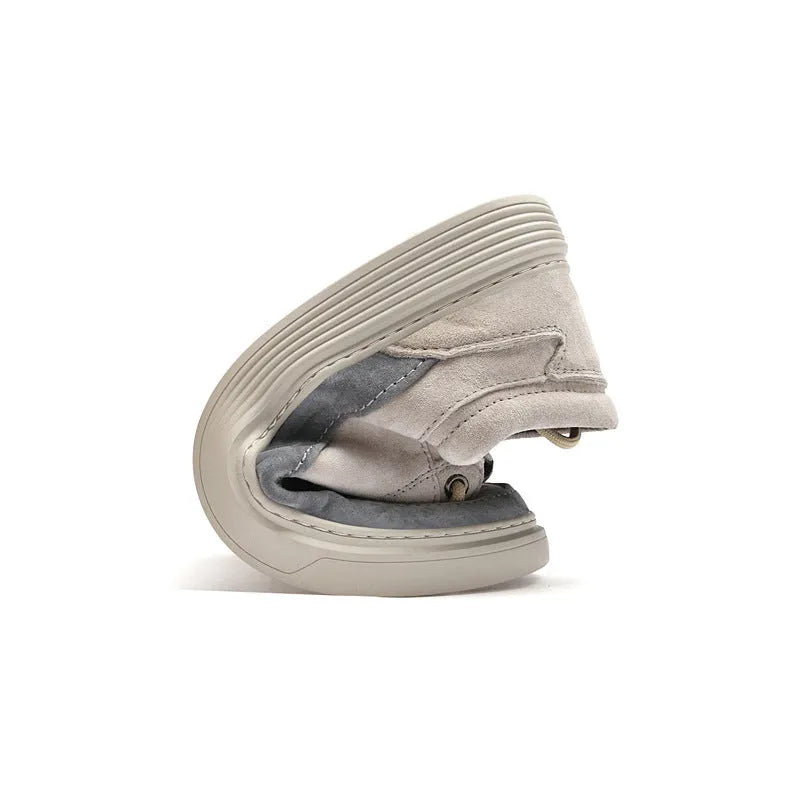 Men's grey low-top casual skate shoes with pigskin leather uppers and a flat rubber sole on a plain background.