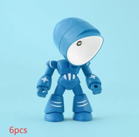 Mini mecha robot hero LED night light with adjustable arms on a desk.
