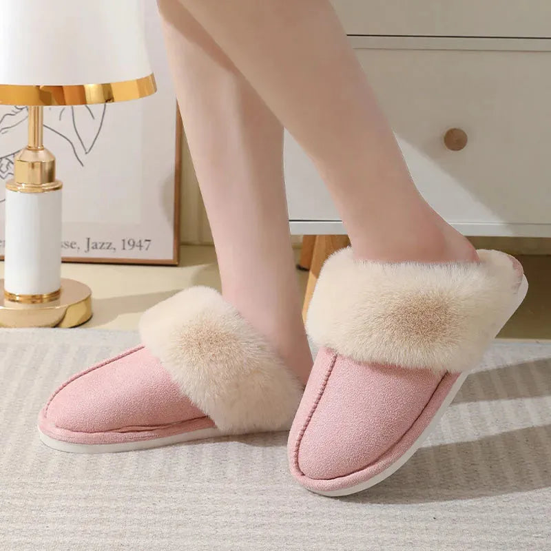 Women's plush winter slippers with round toe, flat heel, and stitching detail on a non-slip PVC sole.