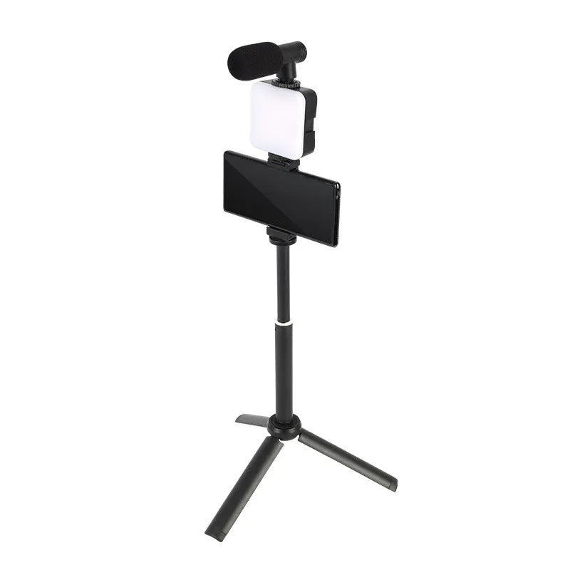 Square LED camera flash with universal hot shoe mount and rotatable head, shown with optional octopus stand tripod.
