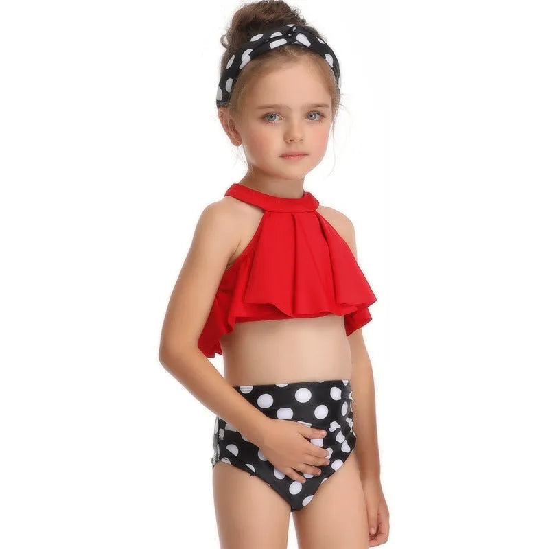 Nylon one-piece swimsuit with chest pad, available in flower, orange, and red, adult and child sizes.