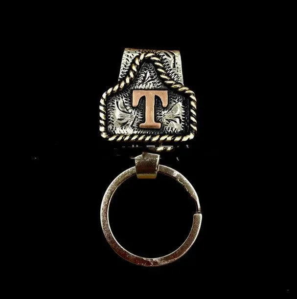 Handmade cow tag design metal keychain on a keyring, shown in one of many available colours.