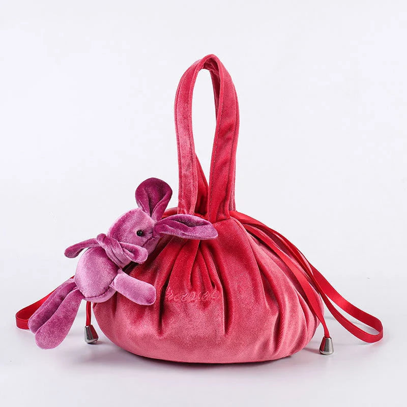 Adorable rabbit ear velvet cosmetic bags in various colors for storing and organizing makeup, toiletries, and other beauty essentials.
