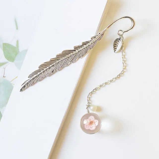 Dried flower bookmark with alloy frame measuring 12cm by 2cm, showing preserved botanical specimens