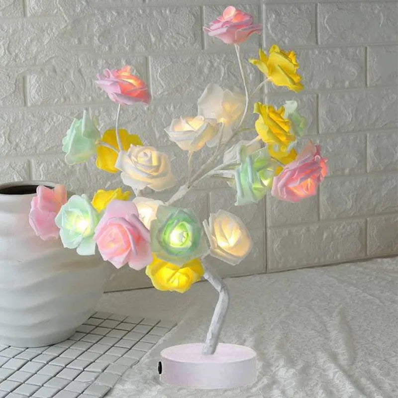 White and red rose flower LED lamp on a table with bonsai tree shape and warm white glow.