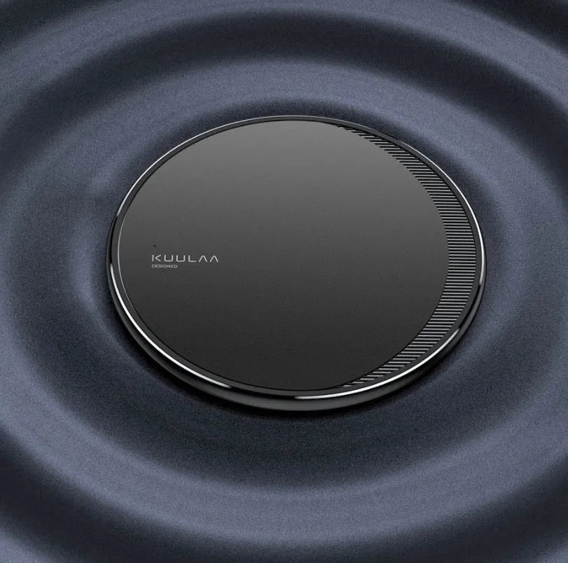 Black circular wireless charging disc for mobile phones with indicator light