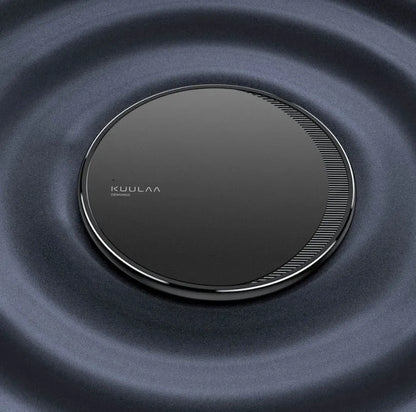 Black circular wireless charging disc for mobile phones with indicator light