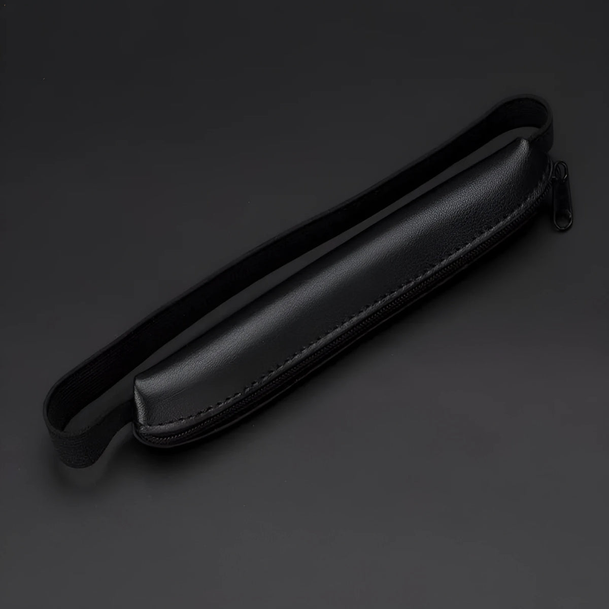 Long beige grey PU leather pencil case on a desk with pens