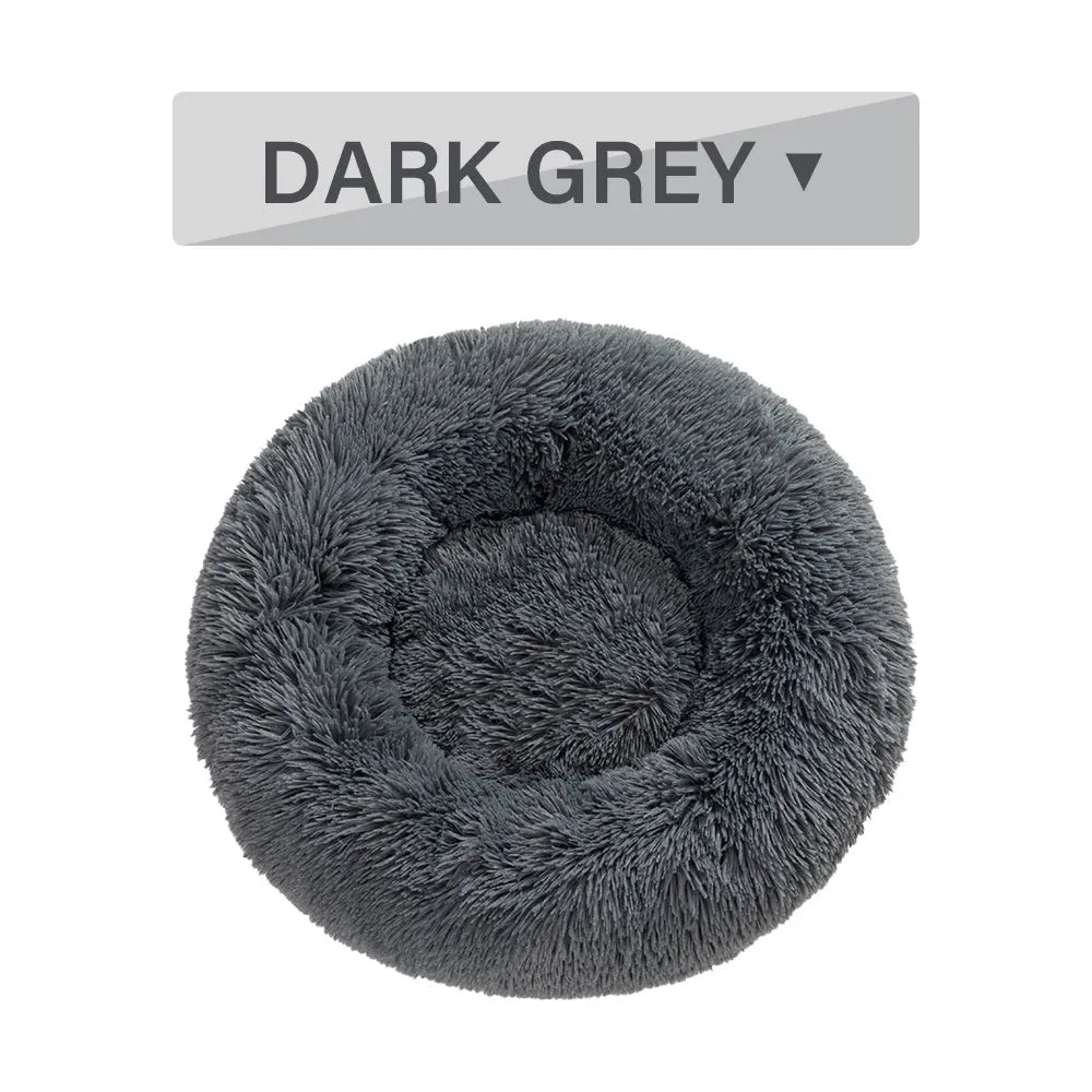 Fluffy donut-shaped pet bed with raised bolster edge in long plush material