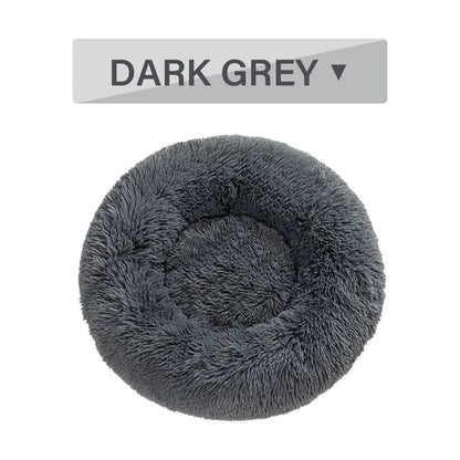 Fluffy donut-shaped pet bed with raised bolster edge in long plush material