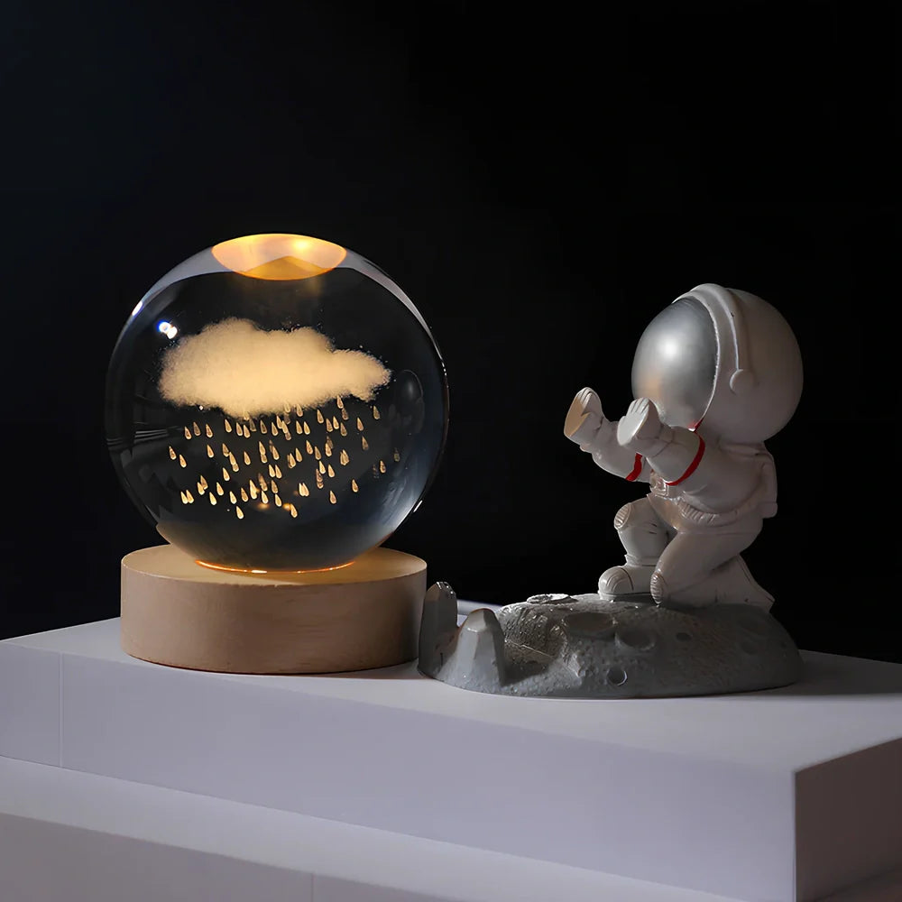 Cosmos Series crystal ball night light with wooden base and astronaut figure, showing Milky Way light pattern