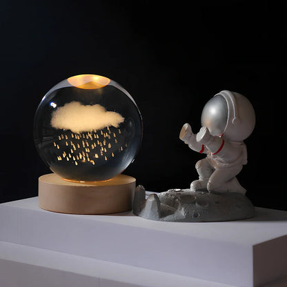 Cosmos Series crystal ball night light with wooden base and astronaut figure, showing Milky Way light pattern